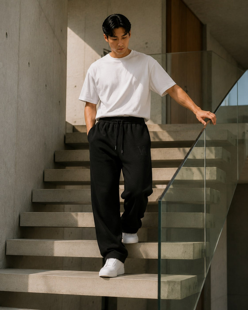 VAELO Foundation Sweatpant in Black — side movement view on stairs